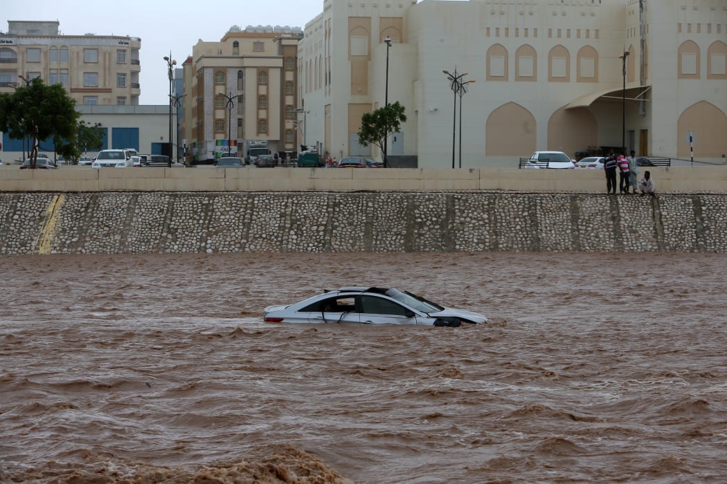 A picture taken on May 26, 2018, shows a car stuck in a flooded street in the southern city of Salalah as the country prepares for landfall of Cyclone Mekunu.