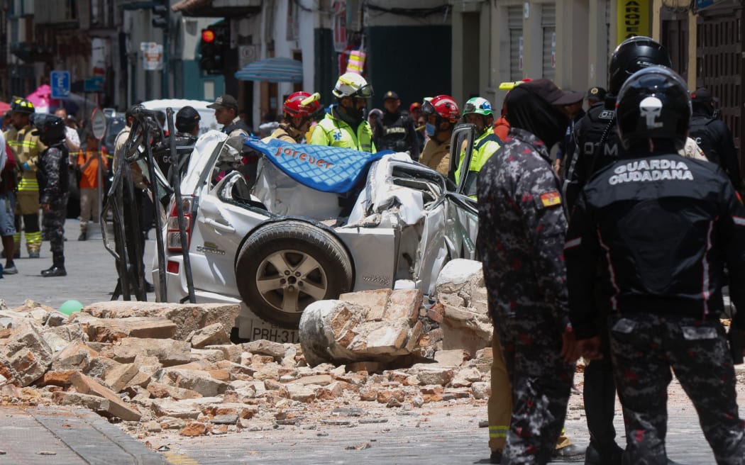 View of a destroyed car after the cornice and terrace of a building located in Cuenca's historic center fell, leaving one dead and one person injured, after an earthquake in Cuenca, Ecuador on March 18, 2023.