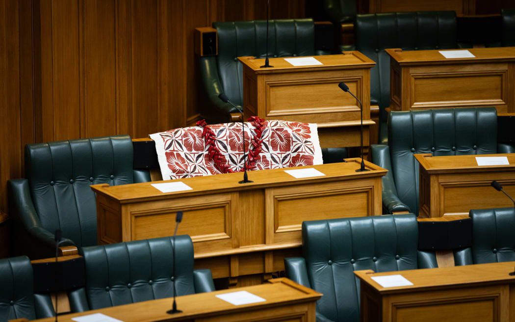 Fa'anānā Efeso Collins' empty chair in Parliament's debating chamber is adorned with a tapa cloth and an ulafala, before MPs arrive to mark his death.