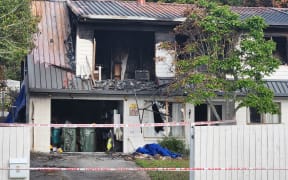 Police guard at the scene of the Bucklands beach double homicide fire.