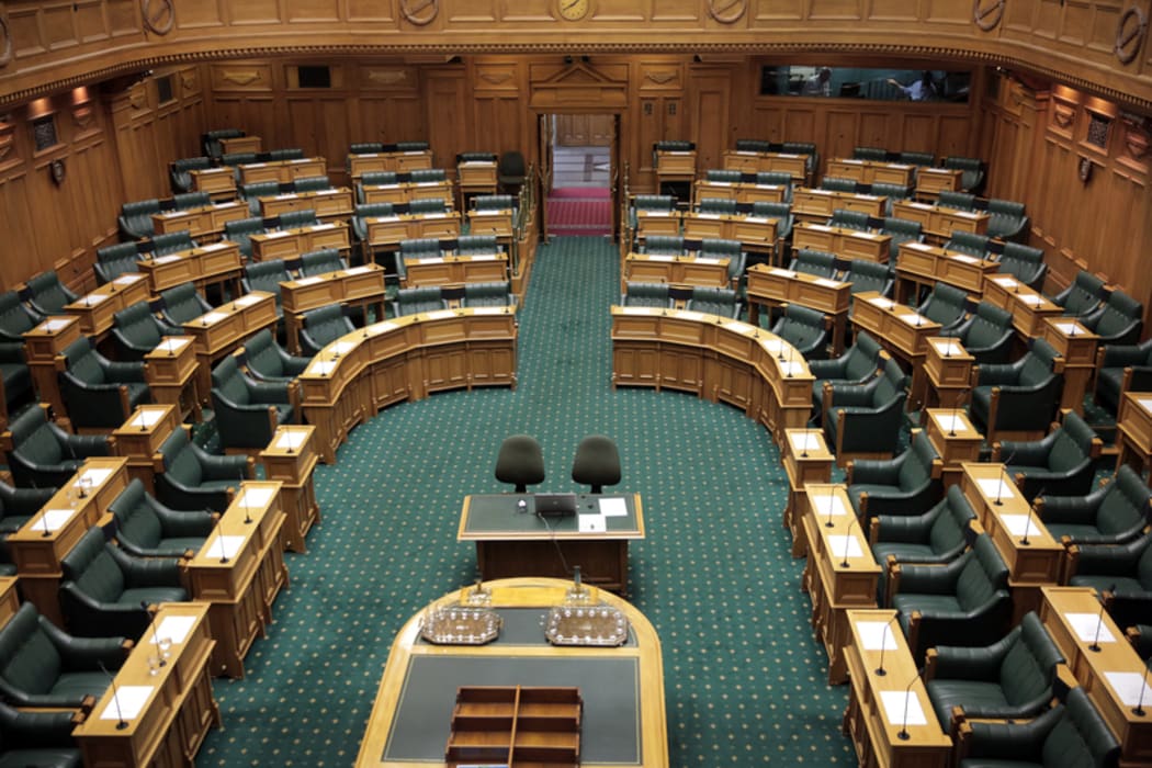 Seats in the empty debating chamber at Parliament
