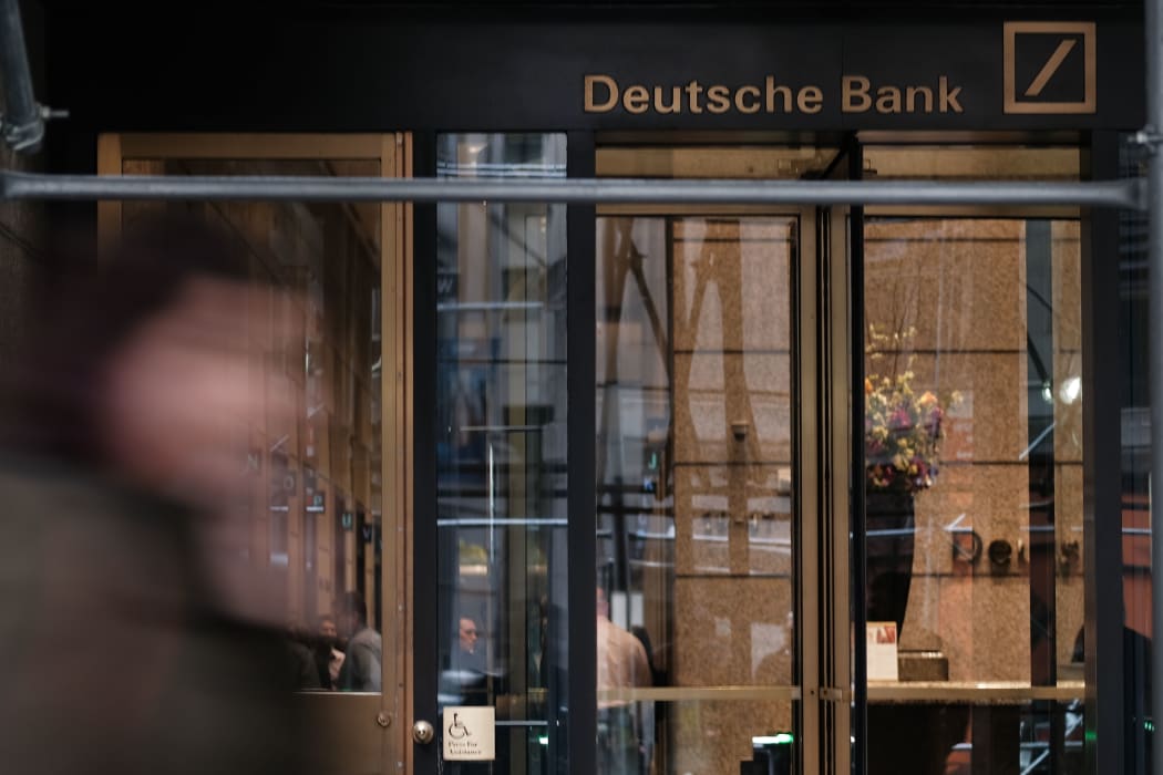 People walk by the New York headquarters of Deutsche Bank, April 2019.