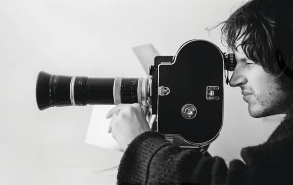 Chris Knox with his Bolex camera filming ‘Turning Brown and Torn in Two’, Auckland, 1983.