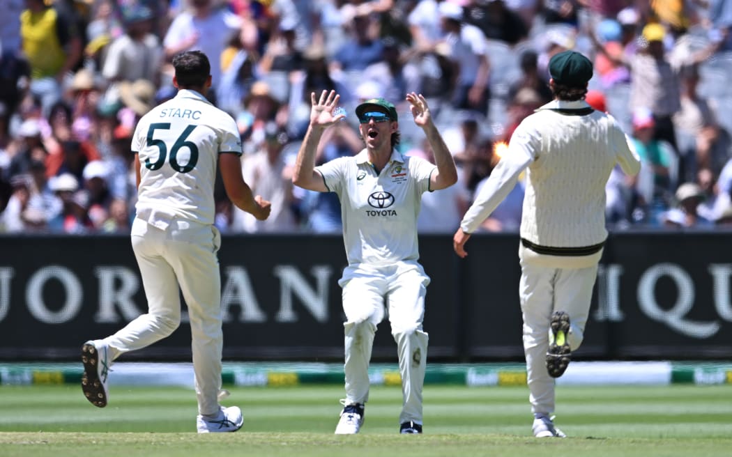 Mitchell Marsh, centre, celebrates with Australian team-mates after the dismissal of Virat Kohli of India on day five of the fourth cricket test at the Melbourne Cricket Ground.