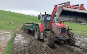 Mark Ensor's tractor is stuck in the mud