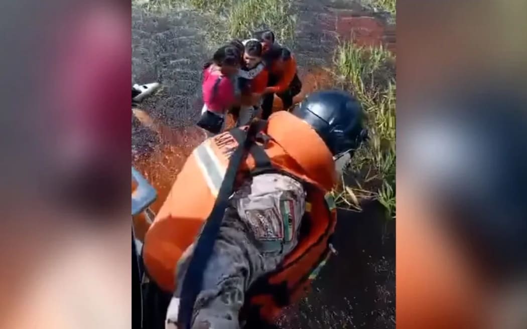 This still from video released by the Bolivian Defense Ministry shows five people being rescued after their plane crashed in an Amazonian jungle. Bolivian Defense Ministry