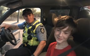 Lucas Sturrock (right) was found by police after driving across paddocks to escape a bushfire.