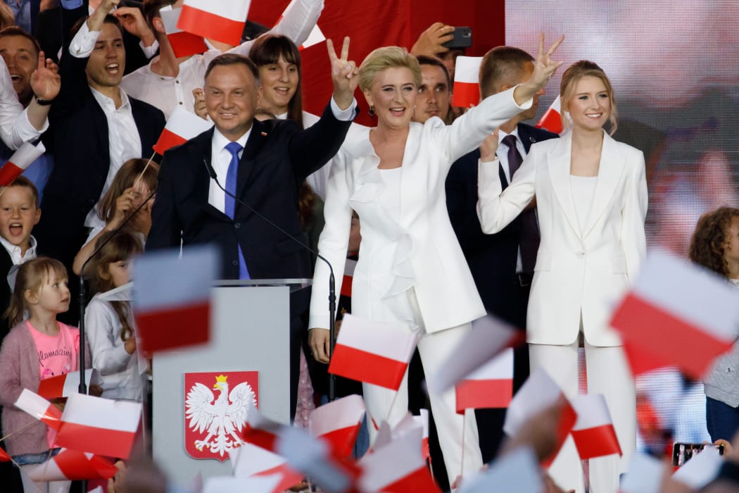 The President of Poland Andrzej Duda, his wife Agata Kornhauser Duda, and daughter Kinga Duda celebrate the initial results during Poland's Presidential runoff elections