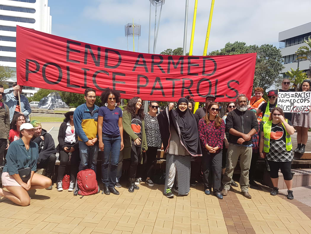 Speakers at the protest against armed police patrols.