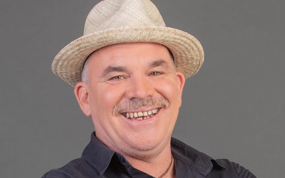 Mark Williams in front of grey background