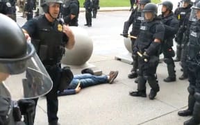 A video by local reporters for public radio station WBFO shows a 75-year-old man being pushed to the ground and bleeding from the head during protests in Buffalo, New York.