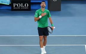 Serbia's Novak Djokovic celebrates after victory against Spain’s Pedro Martinez during their men's singles match on day two of the Australian Open tennis tournament in Melbourne on January 19, 2026. (Photo by IZHAR KHAN / AFP) / -- IMAGE RESTRICTED TO EDITORIAL USE - STRICTLY NO COMMERCIAL USE --
