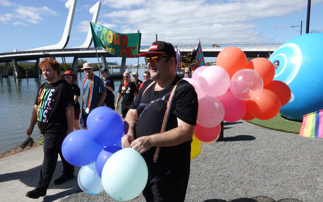 Marchers in Whangārei’s Pride Parade pass the city’s landmark Te Matau ā Pohe bridge.