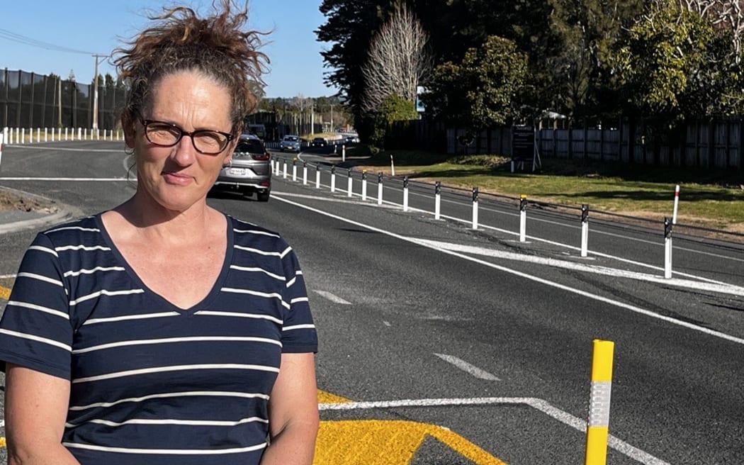 Aongatete resident Kirsten Warbrooke in front of the new median barrier causing frustration on State Highway 2 near Katikati.