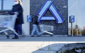 Customers are seen with shopping carts at an Aldi supermarket in Luenen, western Germany, on 5 March, 2021.