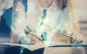 International business hologram over hands taking notes background. Concept of success. Multi exposure