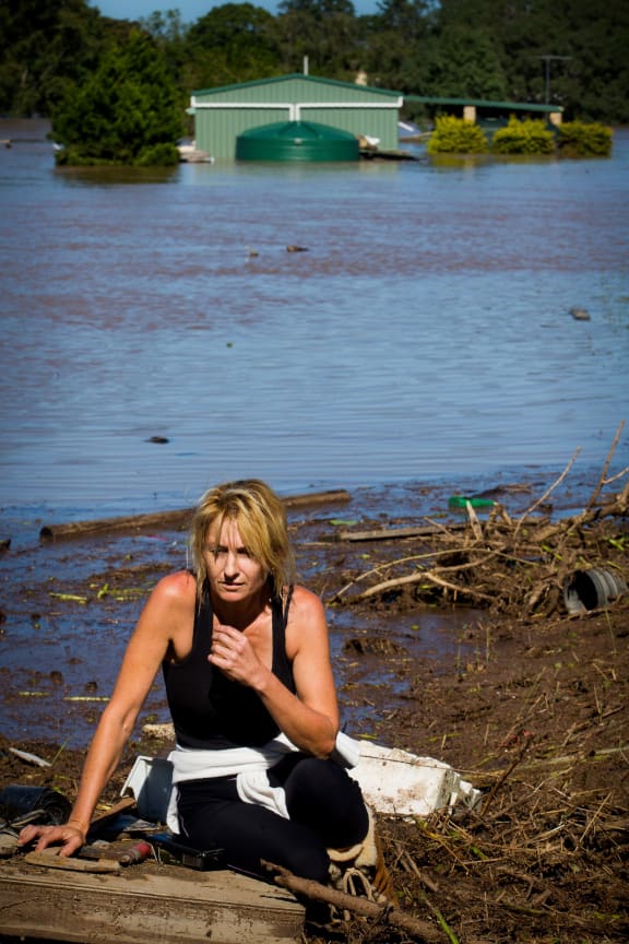 Cassey Bentley reacts to the discovery of her flooded home in North MacLean, Brisbane on April 1, 2017, which was submerged under floodwaters caused by Cyclone Debbie.