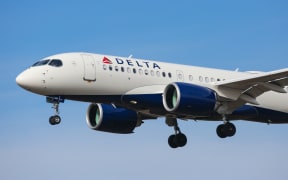 Delta Air Lines Airbus A220-100 aircraft as seen on final approach landing with landing gear down at New York JFK John F. Kennedy International Airport on 14 November 2019 in New York, US.