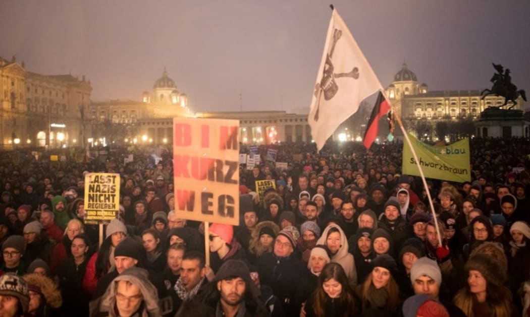 Protesters take part in a demonstration against the current Austrian government at the Heldenplatz in Vienna.