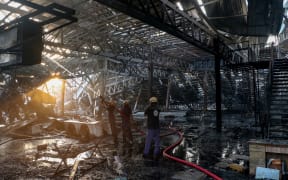 Firefighters extinguish a fire which broke out at an amusement park facility in Rajkot, in India's Gujarat state on May 25, 2024.  (Photo by AFP)