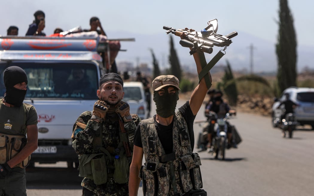 Fighters from Bedouin tribes gather in the al-Mazraa village in Syria's southern Sweida governorate, as clashes with Druze gunmen continue on 18 July, 2025.