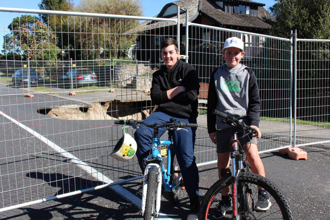 Jono Park (left) and Bailey Malloy (right) in front of the sinkhole in Taupō.