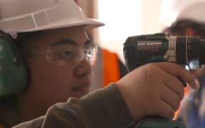 Women working in trades, construction.