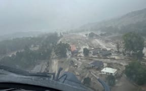 An NH90 helicopter and crew recover people from the rooftops of their homes in Esk Valley, Napier.