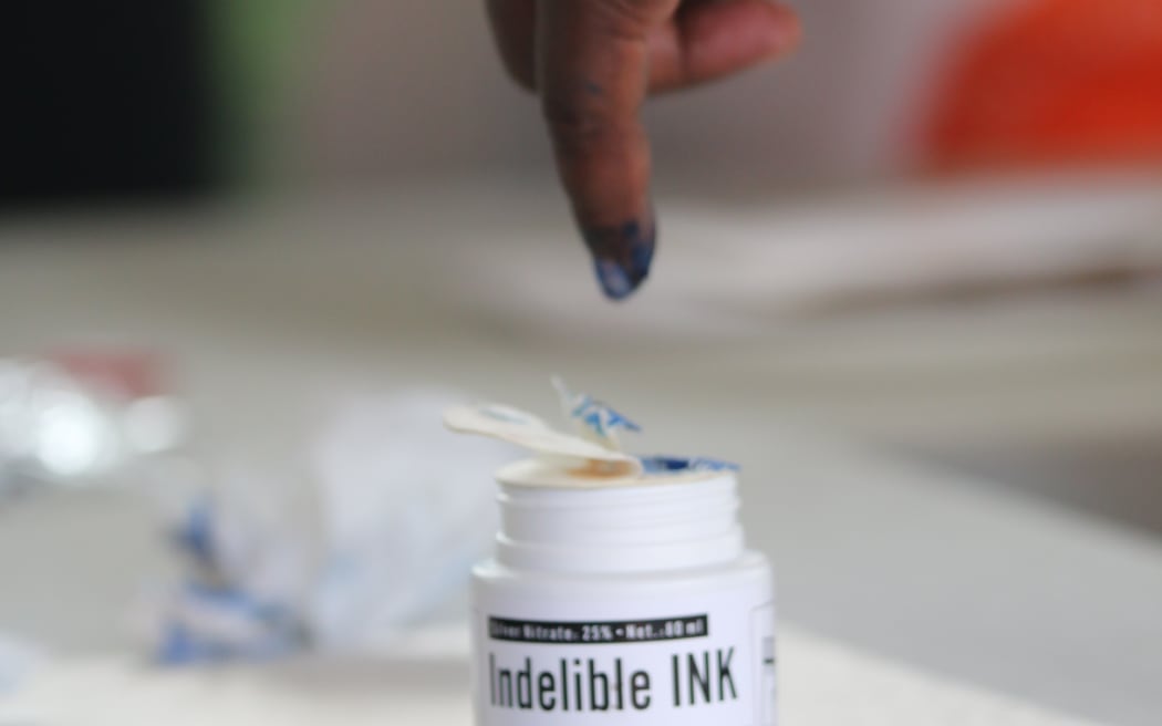 A voter in Solomon Islands dips their finger in indelible ink a preventative measure against double-voting. 17 April 2024