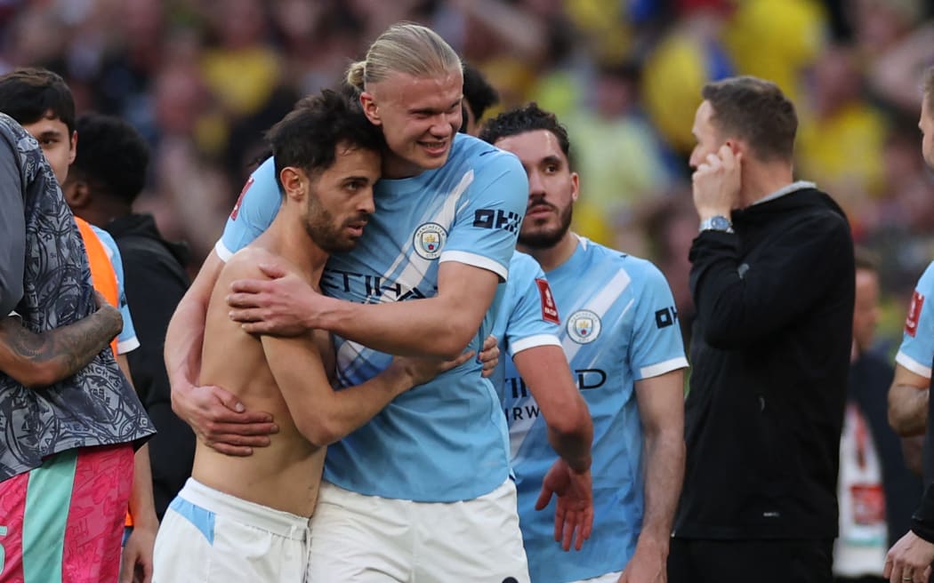 Manchester City's Portuguese midfielder Bernardo Silva (L) and striker Erling Haaland celebrate their FA Cup semi-final win over Southampton.