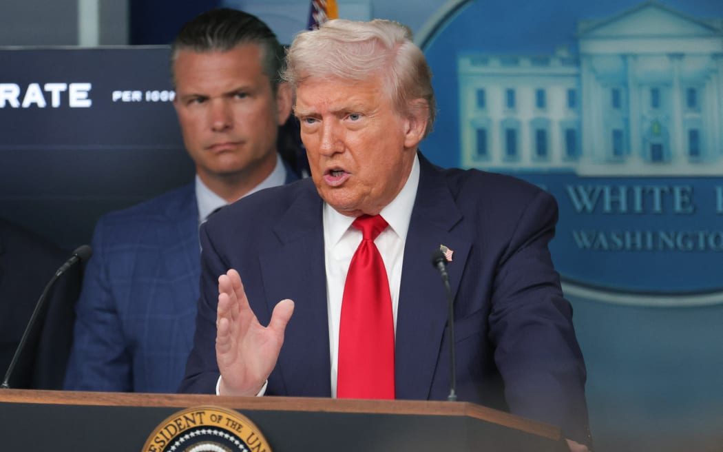 Flanked on stage by U.S. Secretary of Defense Pete Hegseth and other administration officials, not pictured, U.S. President Donald Trump speaks at a press conference at the White House in Washington, D.C. on August 11, 2025. Trump announced the deployment of the National Guard and federalization of the Metropolitan Police Department to combat crime in the city.