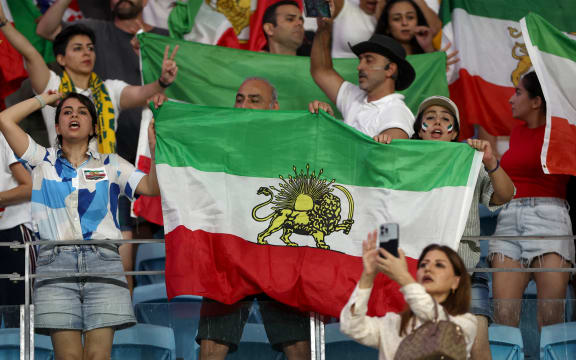 Iranian fans wave Pahlavi-era flags during the AFC Women’s Asian Cup match between Iran and Australia.