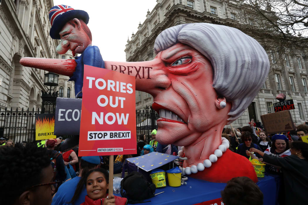 A puppet head of Britain's Prime Minister Theresa May spearing a representation of the British Economy is positioned on Whitehall outside Downing Street.