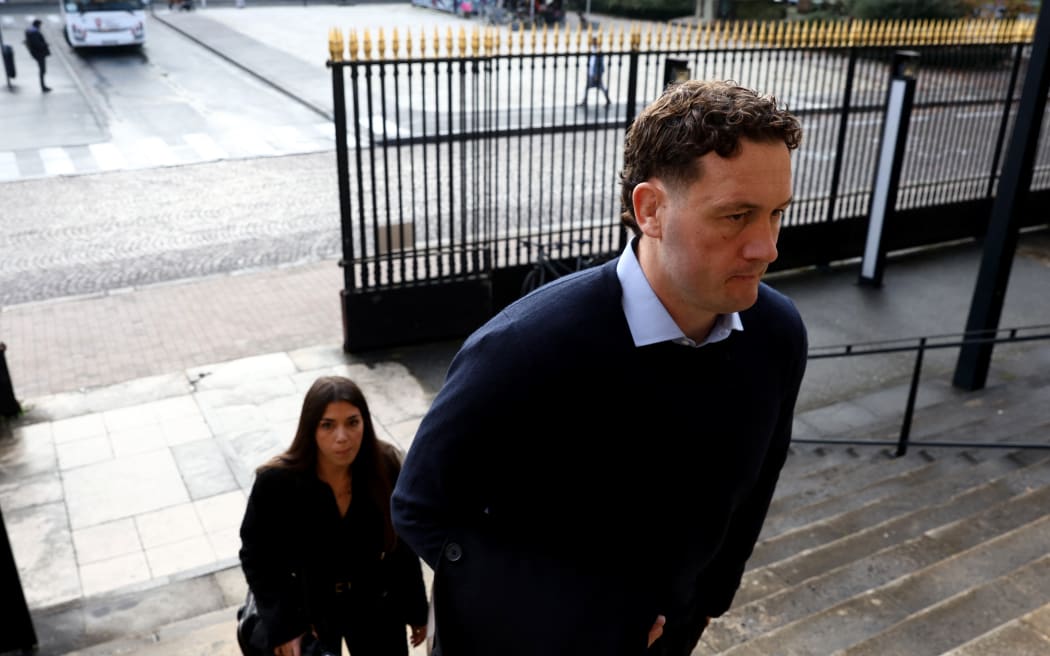 (FILES) New Zealander rugby player Rory Grice (R), who is accused of gang rape, arrives for his trial at the Bordeaux courthouse, in Bordeaux south-western France, on December 2, 2024. - Sentences of 12 to 14 years' imprisonment were requested on December 12, 2024 against former Grenoble rugby players who went on trial on December 2, 2024 accused of raping a student in a hotel in 2017, or failing to prevent the alleged sexual assault. (Photo by ROMAIN PERROCHEAU / AFP)