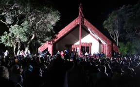Hundreds gather in the dark at Te Tiriti o Waitangi marae for Waitangi Day celebrations.