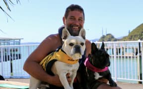 The man behind Bosco, Dylan Bacher, and his "equally spirited" companion Treasure, said the decision to have Bosco surf with the He Whakaputanga flag was a sign of support and love.