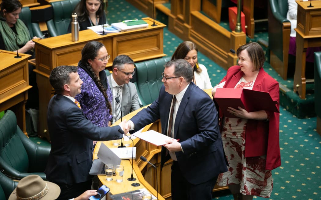 Finance Minister Grant Robertson (centre) and Deputy Finance Minister Megan Woods (behind him with red box) hand over copies of the Budget 2023 to leaders of other parties, 18 May 2023.
