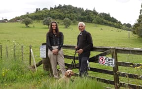 Ngāti Kahu o Torongare spokeswoman Nicki Wakefield and kaumatua Richard Shepherd, with Tamaki the dog and Onoke Pā in the distance.