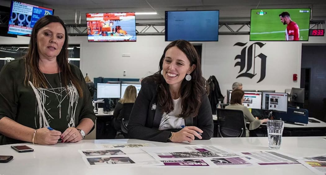 PM Jacinda Ardern propping a special suffrage edition of the New Zealand Herald with editor Miriyana Alexander.