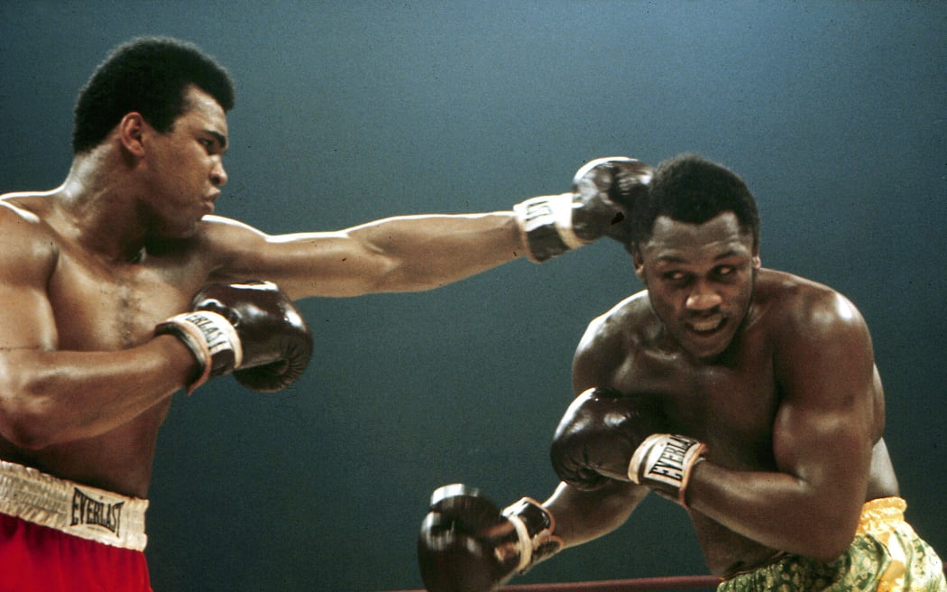 Muhammed Ali (Cassius Clay) punches Joe Frazier during their boxing match, 1971.