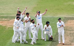 Ajaz Patel of New Zealand celebrates with his team