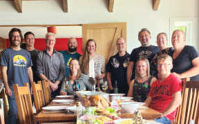 Katie Dugan, seated centre, with friends and family at her 2022 "Friendsgiving" Thanksgiving dinner in Queenstown.