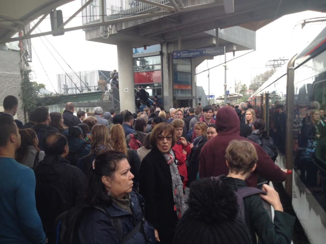 Hundreds of train commuters wait at Kingsland station after a fault caused widespread delays.