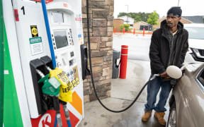 Tavon Clodfelter watches the petrol pump anxiously in Fayetteville, North Carolina, on 12 May. Most stations in the area along  have been without fuel following the hack of the Colonial Pipeline.