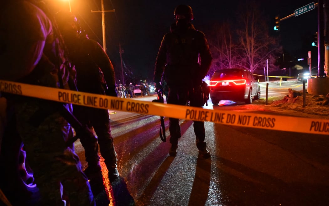 Federal law enforcement agents and police officers in riot gear stand behind a police tape as protests broke out following the shooting of a Venezuelan man by a Immigration and Customs Enforcement (ICE) agent in Minneapolis, Minnesota, on January 14, 2026. A federal immigration agent shot a man January 14 in Minneapolis, city officials said, urging the public to "remain calm" a week after agents shot and killed an American woman in the same city.
Minneapolis Police Chief Brian O'Hara said the shooting resulted from a struggle in front of a residence between a man and an Immigration and Customs Enforcement (ICE) agent on the north side of the city. (Photo by Octavio JONES / AFP)