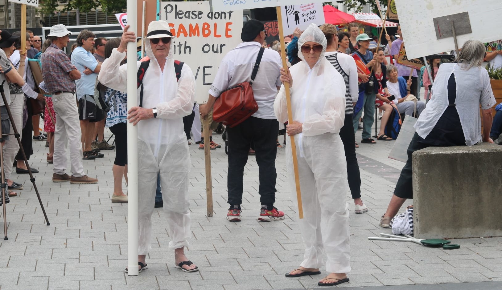 About 200 anti-5G protesters have swarmed central Christchurch with placards, hazmat suits and songs about radiation.