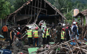 Rescuers look for survivors along the coast on South Sumatra, after the area was hit by a tsunami following an eruption of the Anak Krakatoa volcano.