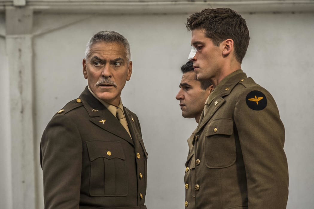 Yossarian (Christopher Abbott), and Clevinger (Pico Alexander), experiencing some military discipline from Scheisskopf (George Clooney), before shipping out Italy in Catch-22.