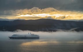 A ship sails through fog in Wellington Harbour on Wednesday.