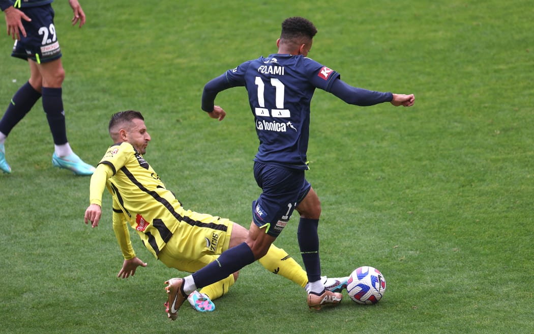 Victory's Ben Folami (R with Phoenix's Kosta Barbarouses during the A-League - Wellington Phoenix v Melbourne Victory at Sky Stadium, 
Wellington on the 01 April 2023. © Copyright image by Marty Melville / www.photosport.nz